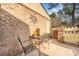 Outdoor patio space featuring brick walls, seating, and a view of mature trees at 8033 Charter Oak Ln, Charlotte, NC 28226