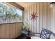 View of porch with wood siding and natural light, including a small table and chair at 8033 Charter Oak Ln, Charlotte, NC 28226