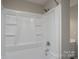 Bathroom tub and shower featuring white tile and gray paint at 8125 Sheringham Way, Charlotte, NC 28227