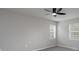 Bedroom with ceiling fan, neutral paint, and sunny windows at 8125 Sheringham Way, Charlotte, NC 28227