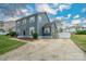 Well maintained two-story home with a driveway leading to a fenced yard and a lush green lawn at 8125 Sheringham Way, Charlotte, NC 28227
