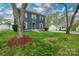 This is an Exterior image of this lovely two-story home with green lawn and tree in the front yard at 8125 Sheringham Way, Charlotte, NC 28227