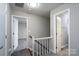 Hallway with carpeted stairs and open doorways leads to various rooms at 8125 Sheringham Way, Charlotte, NC 28227