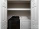Laundry closet featuring side by side washer and dryer and overhead shelving at 8125 Sheringham Way, Charlotte, NC 28227