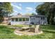 Expansive backyard featuring a seating area, lush greenery, and a brick-exterior home at 842 E Woodlawn Rd, Charlotte, NC 28209