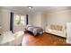 Comfortable bedroom with hardwood floors, neutral walls, and ample natural light at 842 E Woodlawn Rd, Charlotte, NC 28209