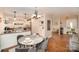 Dining area open to the kitchen, featuring hardwood floors and modern light fixtures at 842 E Woodlawn Rd, Charlotte, NC 28209