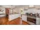 Bright kitchen boasts white cabinetry, granite countertops, and stainless steel appliances at 842 E Woodlawn Rd, Charlotte, NC 28209