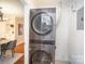 Efficient laundry area with modern, stacked washer and dryer units at 842 E Woodlawn Rd, Charlotte, NC 28209