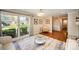 Bright living room featuring hardwood floors, neutral walls, and large window at 842 E Woodlawn Rd, Charlotte, NC 28209