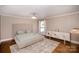 Comfortable main bedroom with hardwood floors, neutral walls, and ample natural light at 842 E Woodlawn Rd, Charlotte, NC 28209