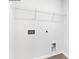 Bright laundry area with white walls, connections, and wire shelving at 890 Two Brothers Ln, York, SC 29745