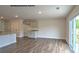 Open-concept space with wood-look floors, ample natural light, leading to a modern kitchen at 890 Two Brothers Ln, York, SC 29745