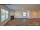 Bright living room showcasing a fireplace, natural light, and wood-look flooring at 890 Two Brothers Ln, York, SC 29745