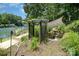 Backyard featuring a pergola, pond, and lush landscaping at 9500 Windygap Rd, Charlotte, NC 28278