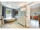 Bright bathroom featuring a clawfoot tub, stylish vanity, and hexagonal tile flooring at 9500 Windygap Rd, Charlotte, NC 28278