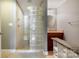 Bathroom showcasing glass block shower, vanity, and modern fixtures at 9500 Windygap Rd, Charlotte, NC 28278