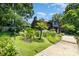 Beautiful modern home featuring a lush, landscaped yard and outdoor entertaining space at 9500 Windygap Rd, Charlotte, NC 28278