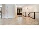 Bright foyer showcasing tile flooring, staircase, and a stylish, decorative doorway at 9500 Windygap Rd, Charlotte, NC 28278