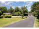 Charming property featuring a well-maintained lawn, outbuilding, and a long private driveway at 9500 Windygap Rd, Charlotte, NC 28278