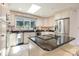 Sunlit kitchen featuring stainless steel appliances, granite counters, and a convenient center island at 9500 Windygap Rd, Charlotte, NC 28278