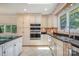 Well-lit kitchen showcasing granite countertops, stainless steel double ovens, and ample cabinet space at 9500 Windygap Rd, Charlotte, NC 28278