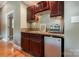 Convenient kitchenette featuring dark cabinets, a sink, countertop appliances, and a small fridge at 9500 Windygap Rd, Charlotte, NC 28278