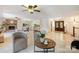 Spacious living area showcasing tile flooring, a dining area, and a charming brick fireplace at 9500 Windygap Rd, Charlotte, NC 28278