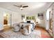 Light-filled main bedroom with an area rug, sitting area, and neutral decor at 9500 Windygap Rd, Charlotte, NC 28278