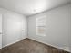 This bedroom features a window and wood-look floors at 10031 Orchard Grass Ct, Charlotte, NC 28278