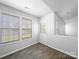 Bright entryway featuring wood-look floors, a white door, and two large windows at 10031 Orchard Grass Ct, Charlotte, NC 28278