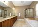Primary bathroom with double sink vanity, soaking tub, and separate glass enclosed shower at 1022 Bimelech Dr, Indian Trail, NC 28079