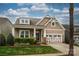 Charming home featuring a decorative front gable, a two-car garage, and a well-maintained lawn at 1022 Bimelech Dr, Indian Trail, NC 28079