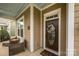 Cozy front porch featuring rocking chairs, decorative door, and craftsman trim accents at 1022 Bimelech Dr, Indian Trail, NC 28079