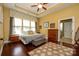 Well-lit main bedroom with hardwood floors, tray ceiling, and en suite bathroom at 1022 Bimelech Dr, Indian Trail, NC 28079