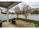 Enclosed patio with a white fence, a gas grill, and a cozy seating area for outdoor entertaining at 1022 Bimelech Dr, Indian Trail, NC 28079