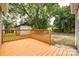 A wooden backyard deck overlooks a spacious yard, perfect for outdoor entertaining and relaxation at 1022 Parker St, Monroe, NC 28112