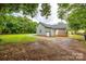An inviting spacious backyard with mature trees, offering ample space for outdoor activities and relaxation at 1022 Parker St, Monroe, NC 28112