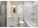 A tidy bathroom with a shower-tub combination that features contemporary fixtures and neutral tones at 1022 Parker St, Monroe, NC 28112
