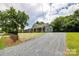 Inviting home with a gravel driveway and welcoming front porch, perfect for relaxing and enjoying the outdoors at 1022 Parker St, Monroe, NC 28112