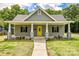 Charming single-Gathering home featuring a welcoming front porch and well-manicured landscaping at 1022 Parker St, Monroe, NC 28112