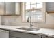 A modern kitchen sink with light-colored counters and stainless steel faucet offer a clean, updated aesthetic at 1022 Parker St, Monroe, NC 28112