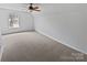 Bedroom with plush carpeting, a ceiling fan, and a view from the window at 10827 Azure Valley Pl, Charlotte, NC 28269