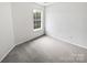 Neutral bedroom with large window offering natural light and plush carpeting at 10827 Azure Valley Pl, Charlotte, NC 28269