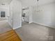 Bright dining room with a modern chandelier and neutral carpet, open to kitchen at 10827 Azure Valley Pl, Charlotte, NC 28269