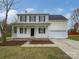 Charming two-story home with a welcoming front porch and attached two-car garage at 10827 Azure Valley Pl, Charlotte, NC 28269
