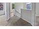 Upstairs hallway featuring new carpeting, large windows, and neutral paint at 10827 Azure Valley Pl, Charlotte, NC 28269
