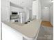 Open kitchen featuring white appliances, cabinetry, and a breakfast bar with seating at 10827 Azure Valley Pl, Charlotte, NC 28269