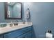 Charming powder room with blue walls, a decorative mirror, and a stylish sink and vanity at 1100 22Nd Ne St # 502, Hickory, NC 28601