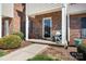 Welcoming front porch of this charming townhouse featuring a cozy seating area, perfect for relaxing at 1100 22Nd Ne St # 502, Hickory, NC 28601